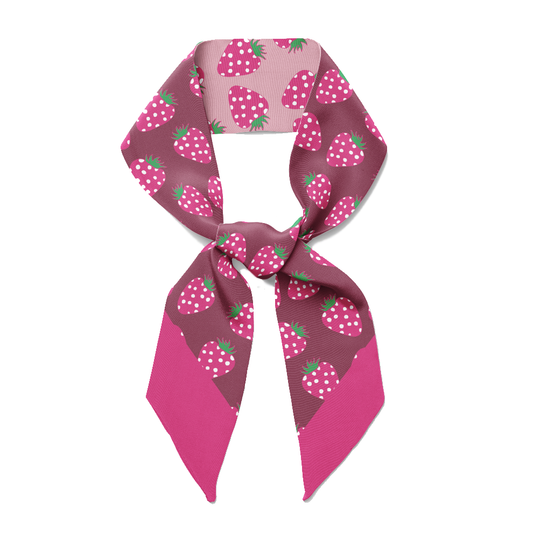 A neon pink twilly bow ribbon silk scarf with strawberries on it.