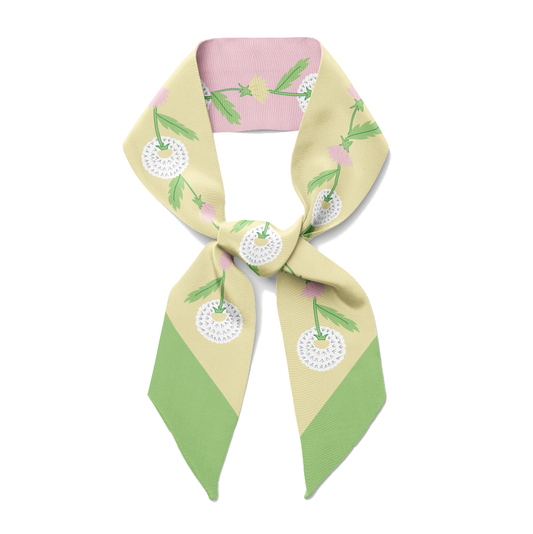 The front of pink and green twilly bow ribbon silkn scarf with dandelion print.