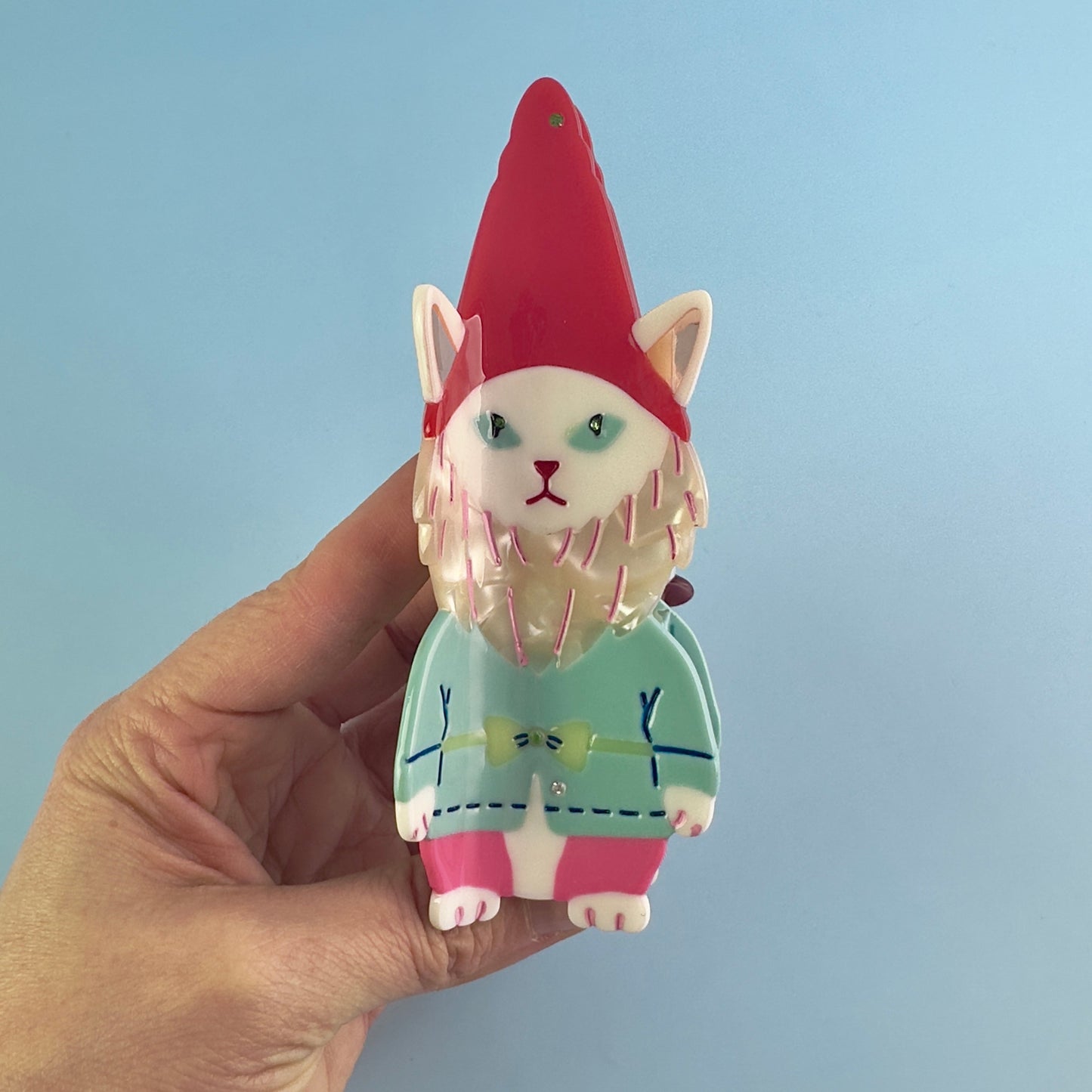 Cat garden gnome From Lawn Ornament to Hair claw Accessory World Traveler in red, blue and pink cellulose acetate from centinelle