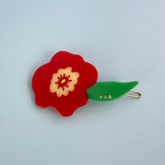 Red flower hair clip from cat garden gnome collection from Centinelle, with green leaf.