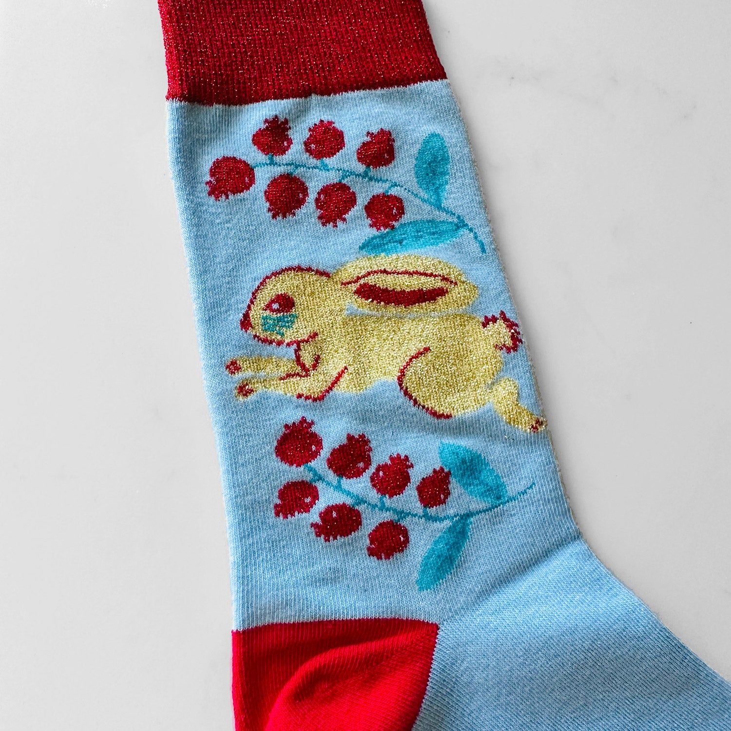 Blue and red sock with rabbit on it.