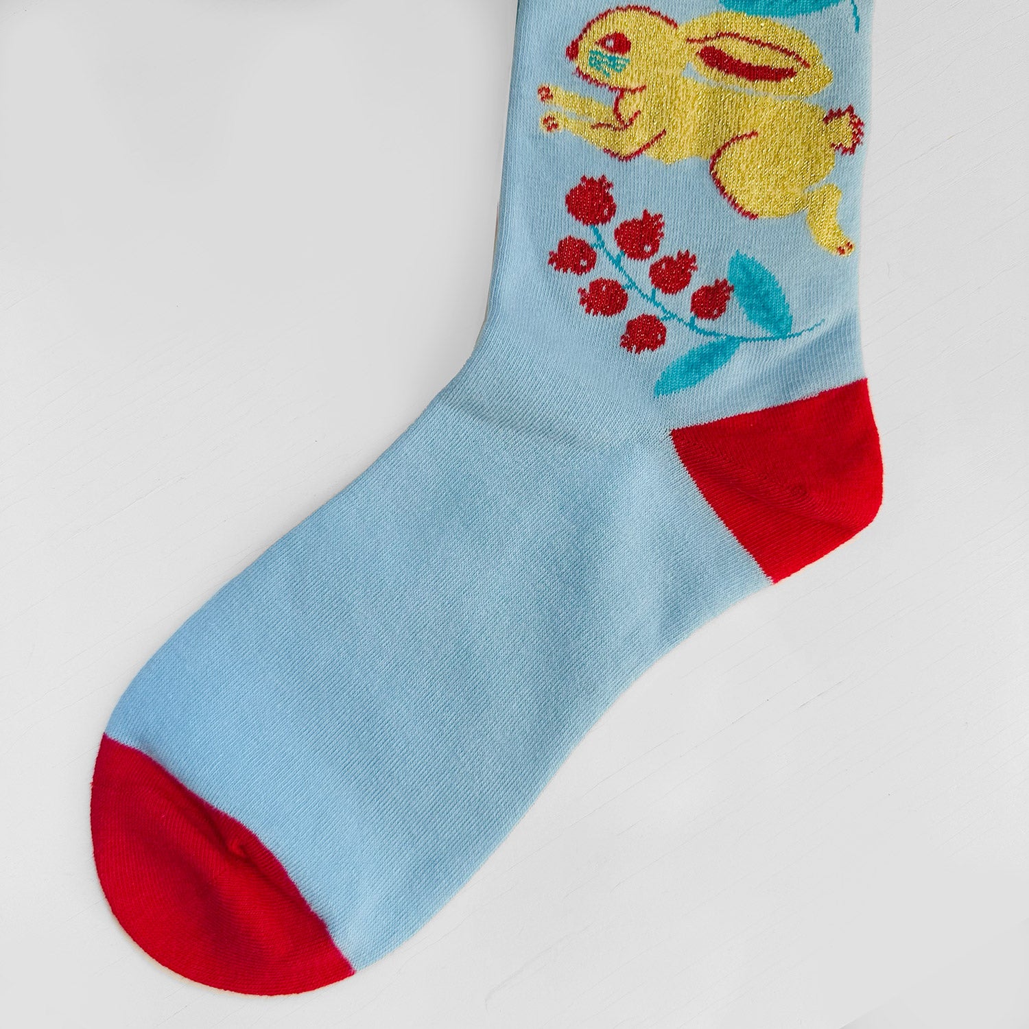 Blue and red sock with rabbit on it.