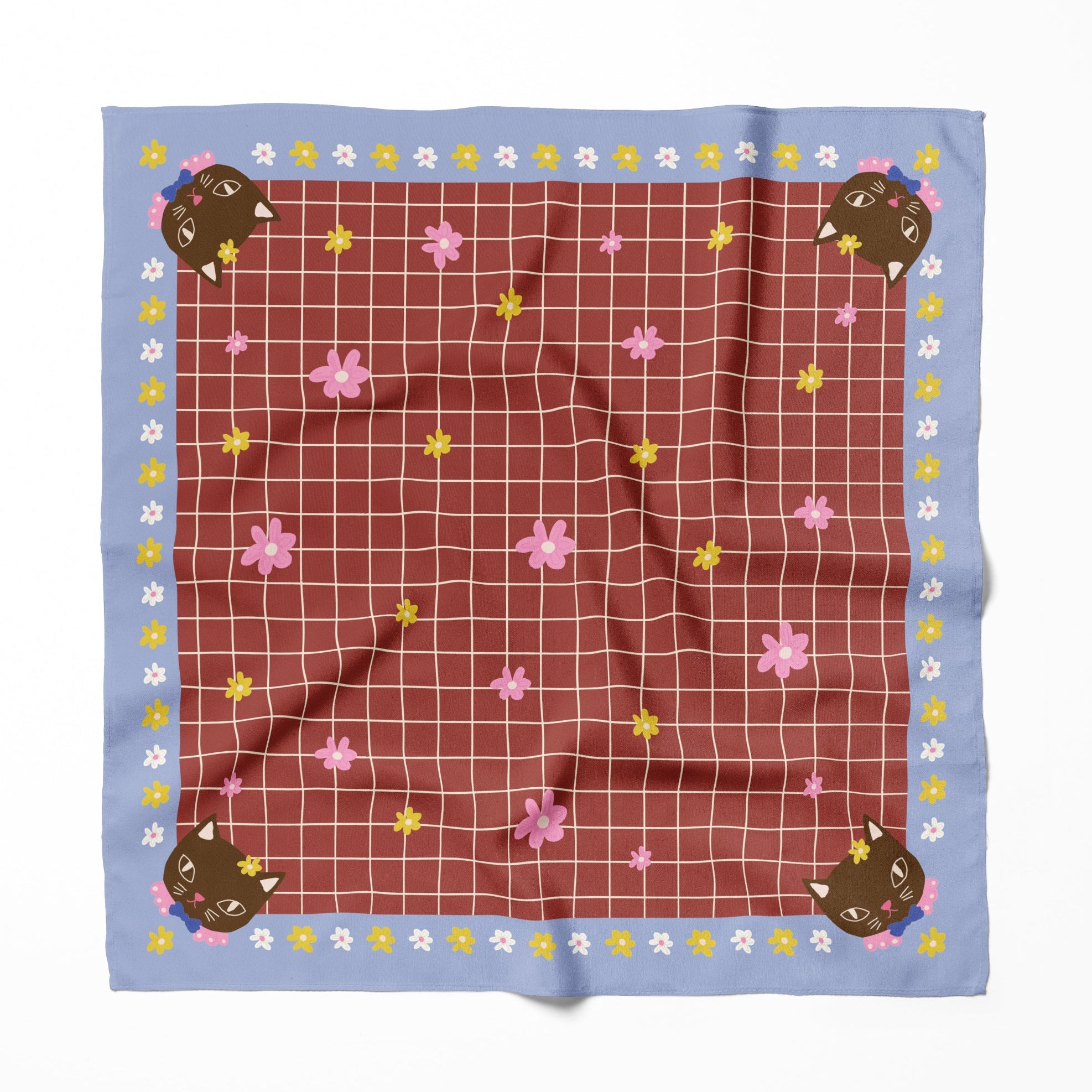 A patterned  cotton silk bandana headscarf with a cat design and plaid in white lines, burgundy and blue, on a plain background