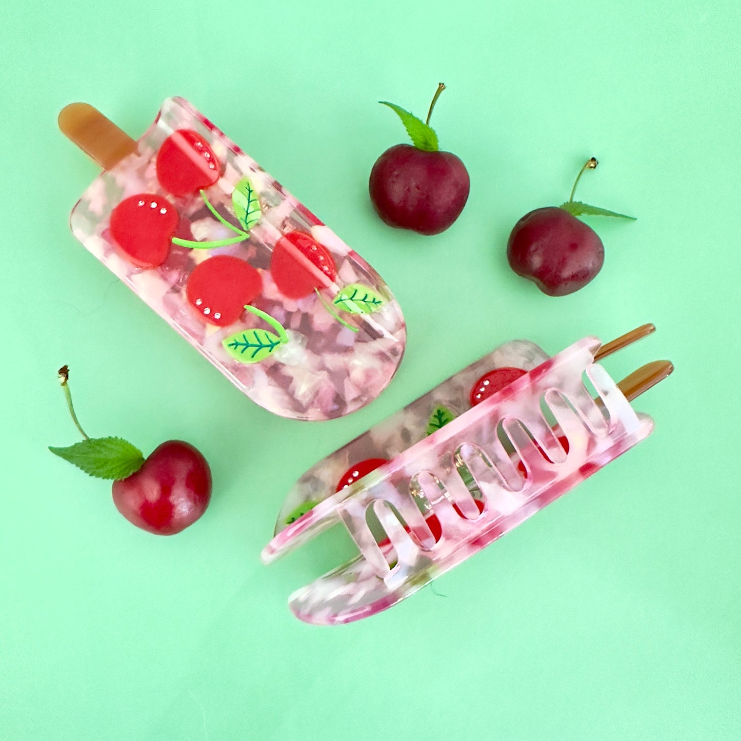 Keep it cool with our Cherry popsicle hair claw, with red cherries with crystals and pink translucent cellulose acetate