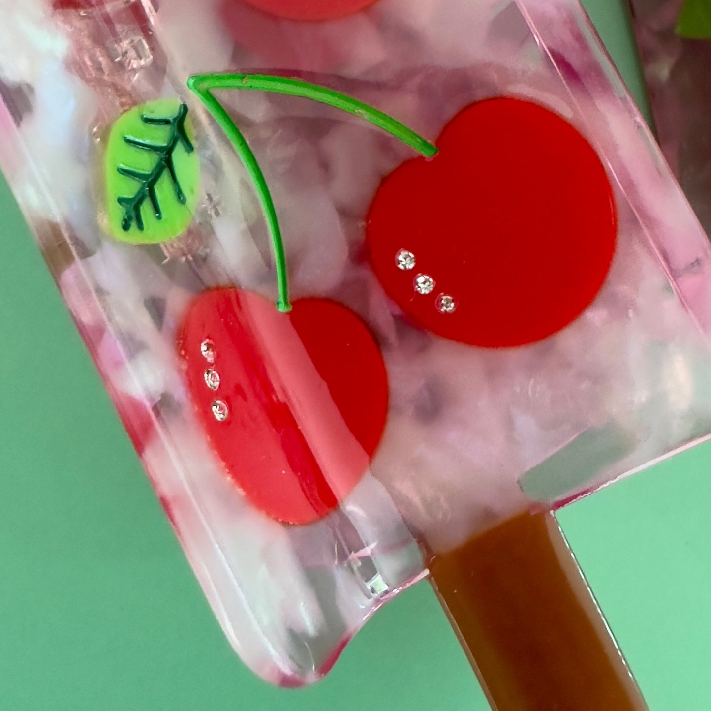 Keep it cool with our Cherry popsicle hair claw, with red cherries with crystals and pink translucent cellulose acetate