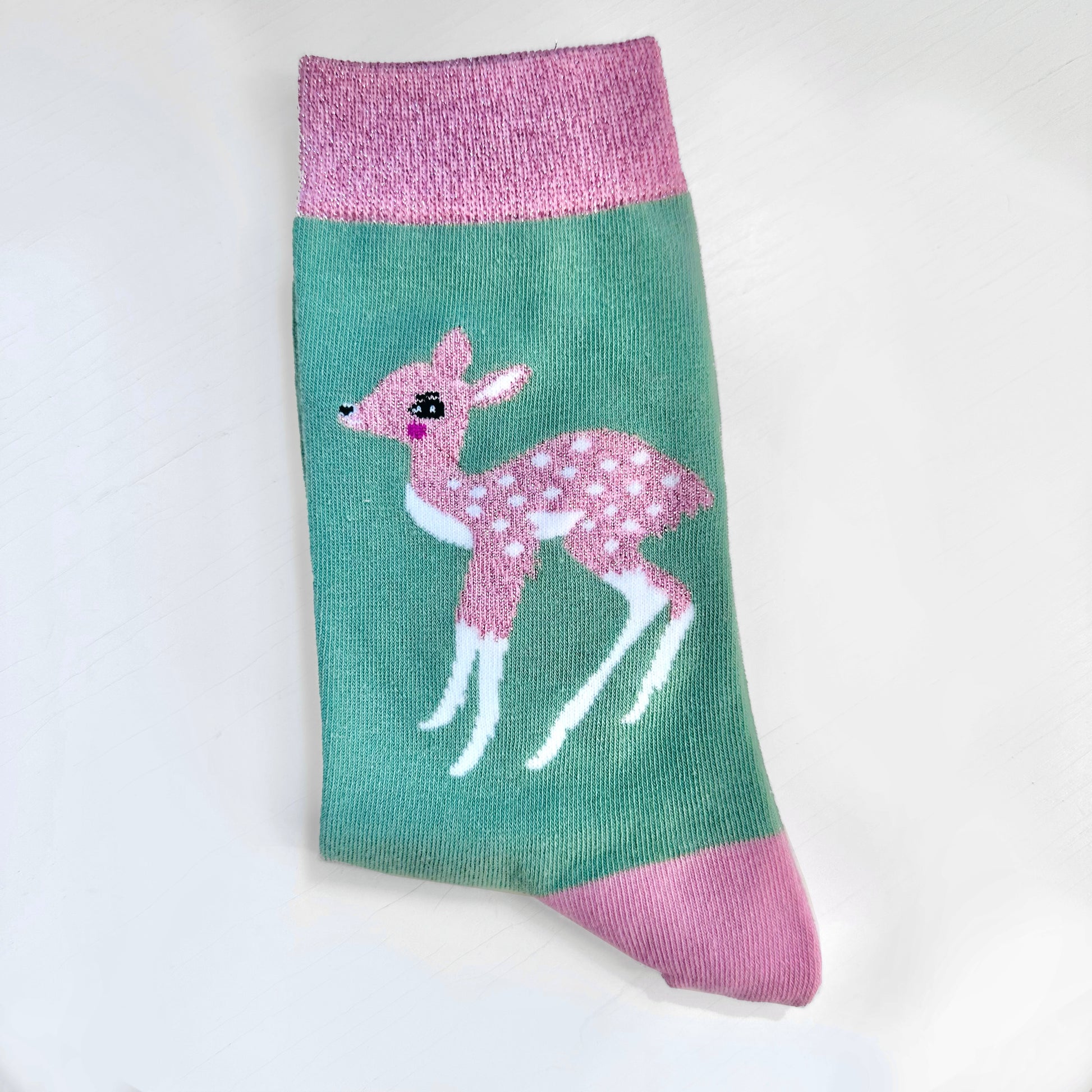 A green and pink sock with a deer on it.