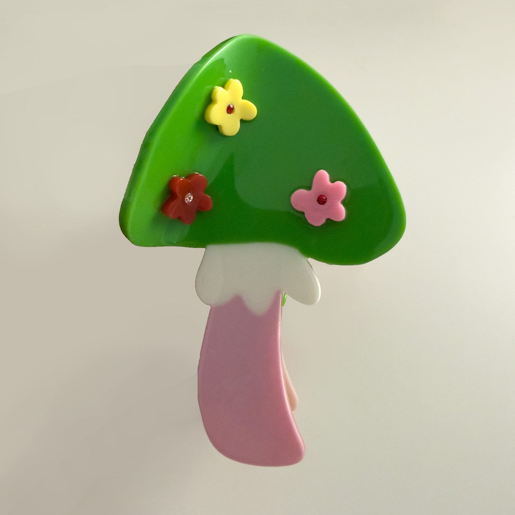 Colorful mushroom-shaped hair claw with flowers on a light gray background