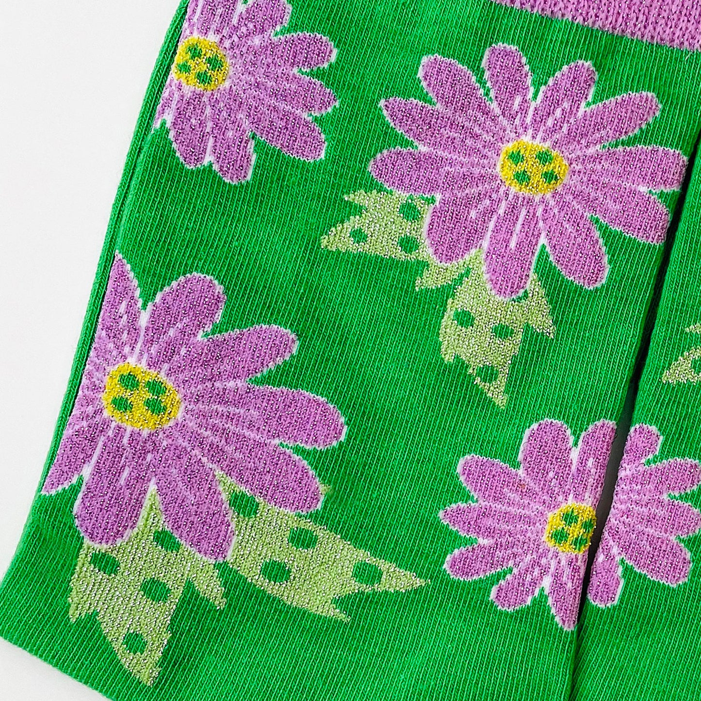 Green socks with purple flowers.