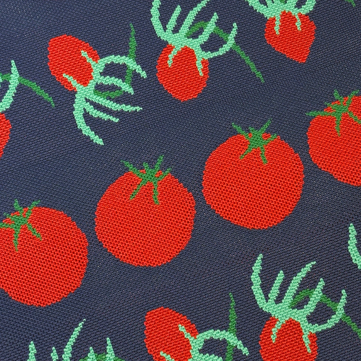 Pattern of red tomatoes with green leaves on a dark blue background
