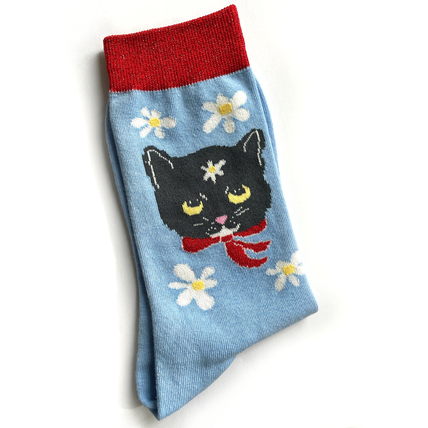Blue sock with black cat and white daisies. 