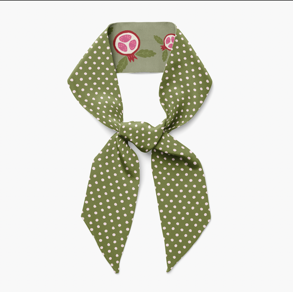 Green polka dot scarf with a matching tag on a white background